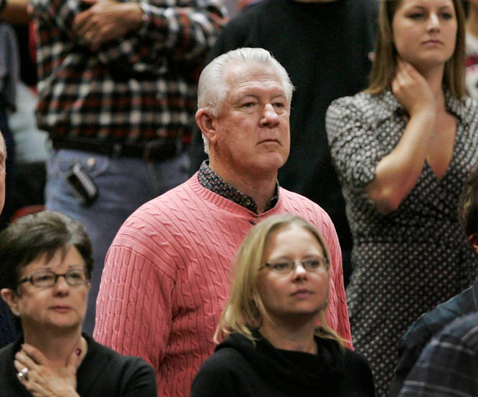 Former Boston Celtics player John Havlicek, center, watches from the stands during the second h ...