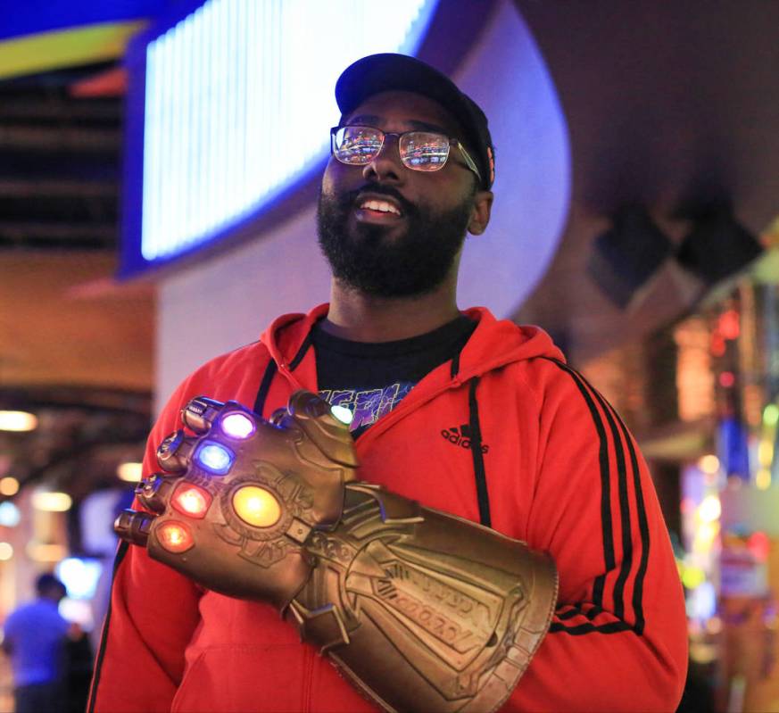 Justin Vinson, 25, wears his Infinity Gauntlet before the first showing of "Avengers: Endgame" ...