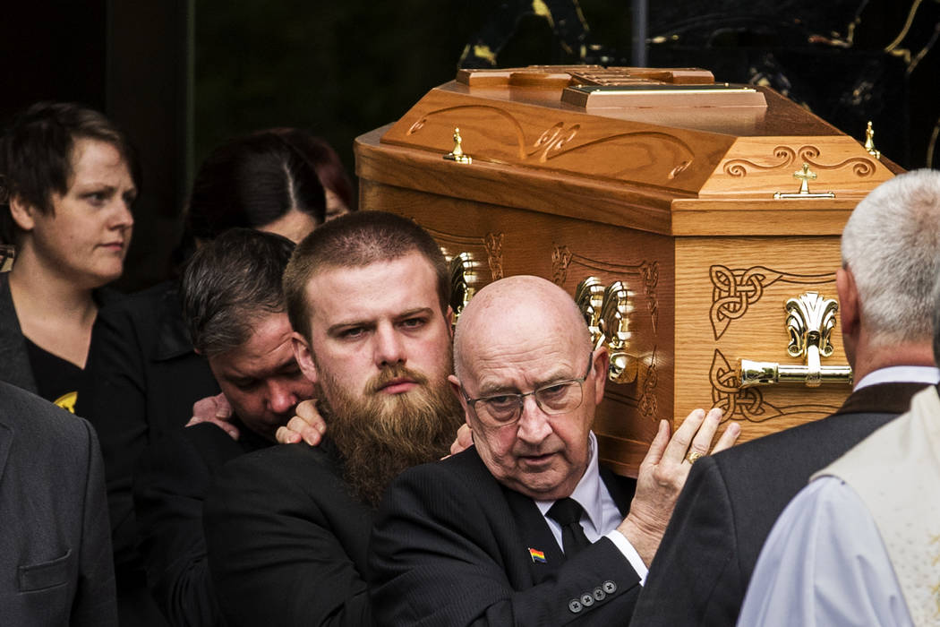 Sara Canning, partner of Lyra McKee, walks behind her coffin as it is carried out of St Anne's ...