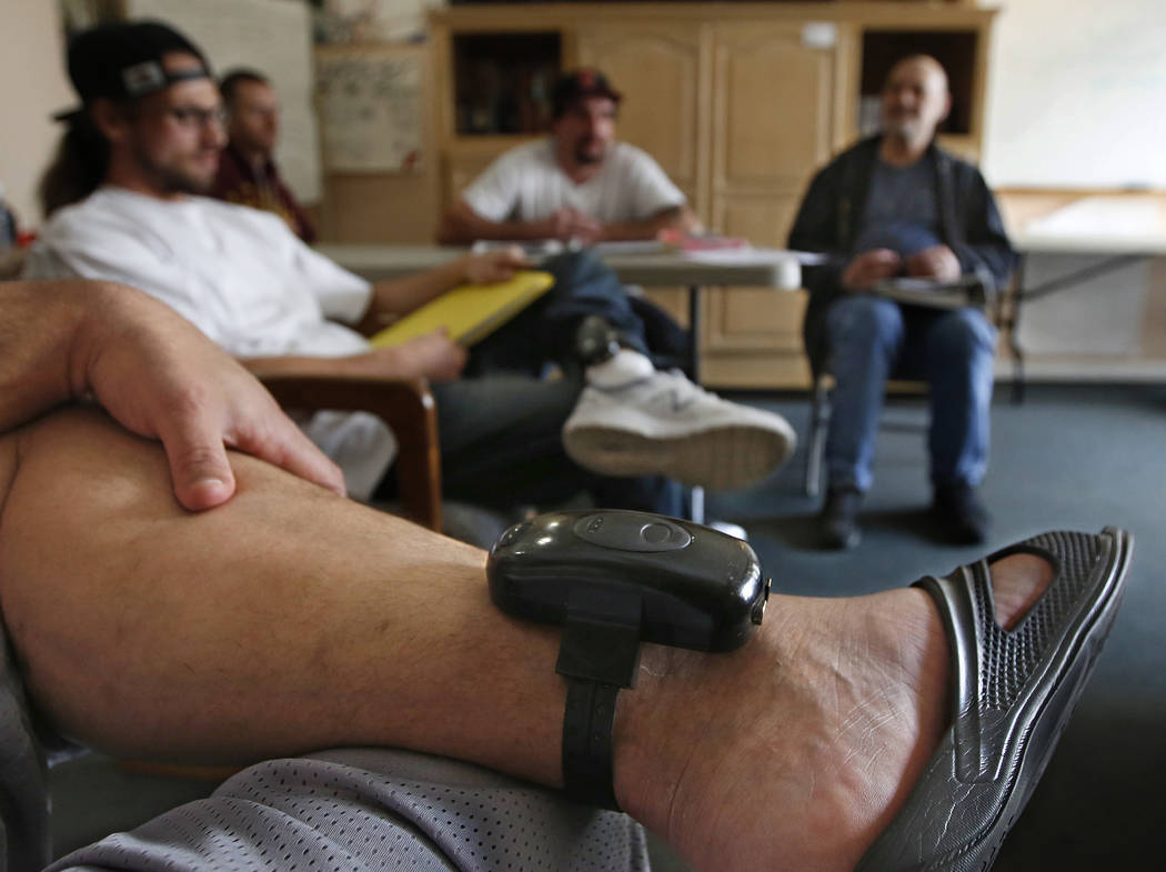 A GPS bracelet is seen Feb. 20, 2019, on the ankle of an inmate attending a discussion about li ...