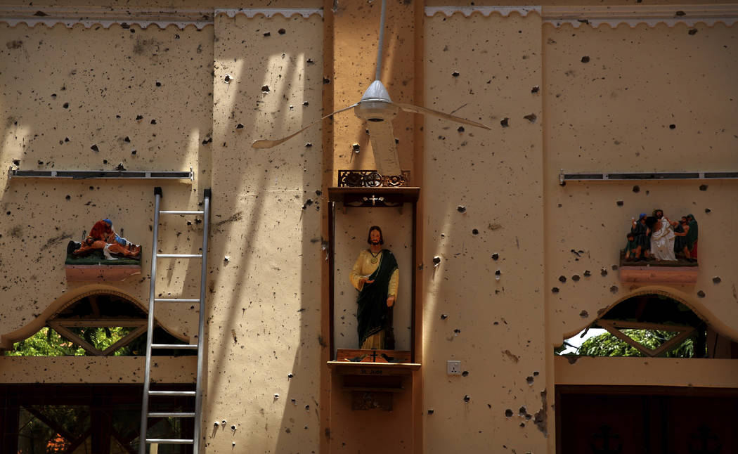 In this Thursday, April 25, 2019 photo, a statue of St. Jude stands on a wall speckled with fra ...