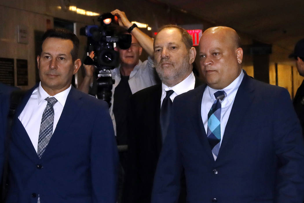 Harvey Weinstein, second from right, enters State Supreme Court in New York, Friday, April 26, ...