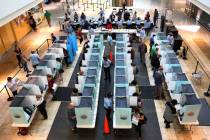 Voters cast their ballots as others sign in at a polling station at Galleria Mall on Tuesday, N ...