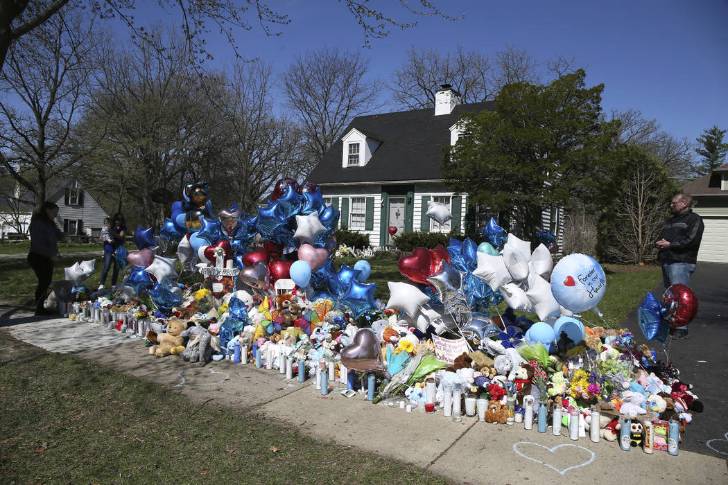 A memorial for 5-year-old Andrew "AJ" Freund grows outside of his family's home on Th ...