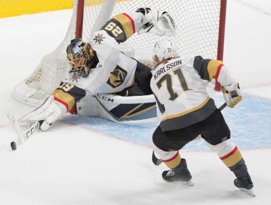 Golden Knights goaltender Marc-Andre Fleury (29) makes a save in the first period with the help ...