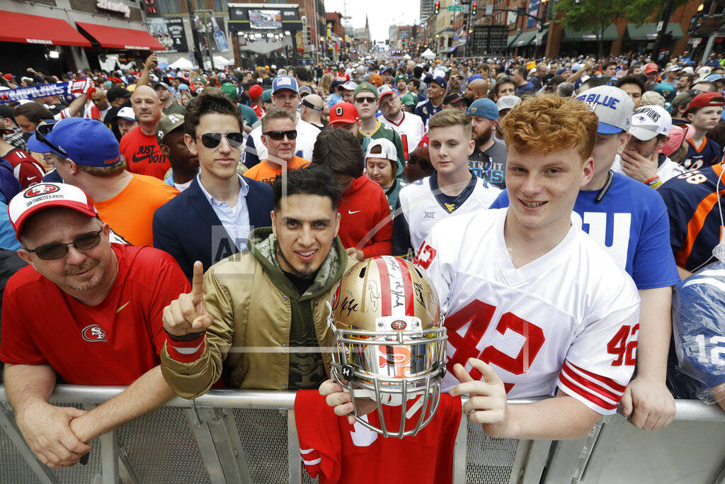 Fans pose for a photo ahead of the first round at the NFL football draft, Thursday, April 25, 2 ...