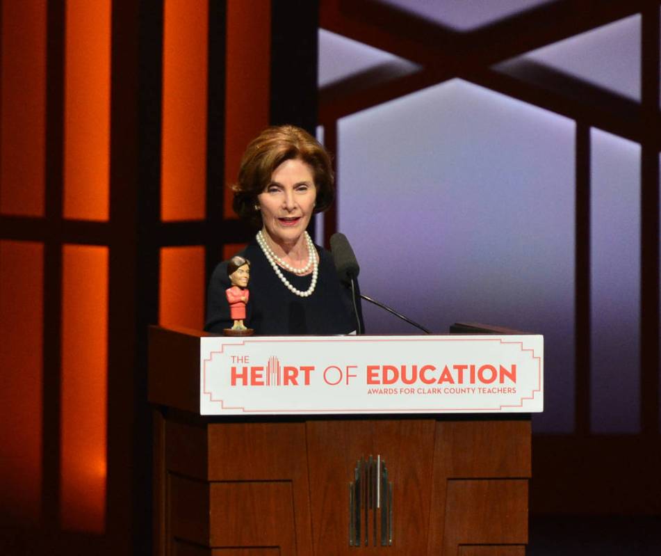 Former first lady Laura Bush places a bobble head of herself on the lectern during the Heart of ...