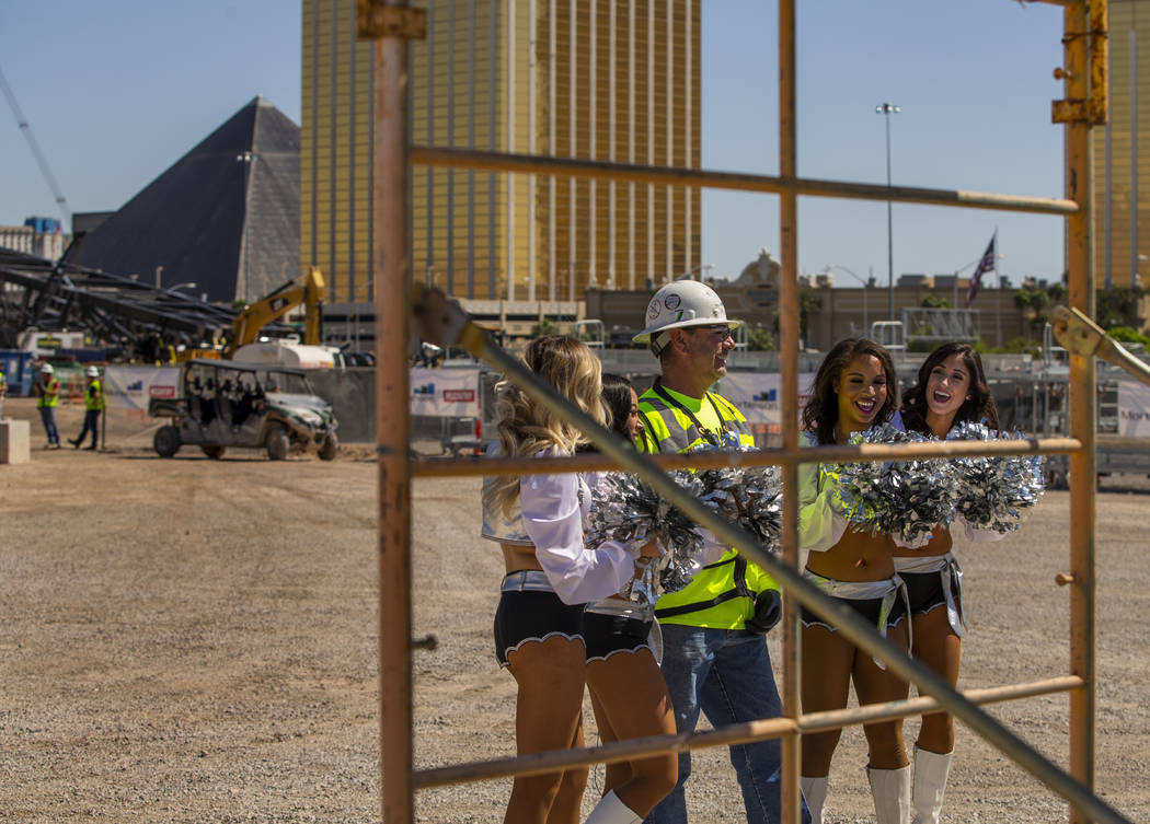 Labor concrete foreman Dave Durbin is flanked by the Raiderettes as he helps the Raiders announ ...