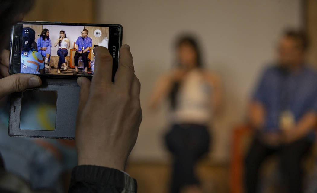 A participant grabs some video of Author Mira Jacob, singer Thao Nguyen and author Josh Kun in ...