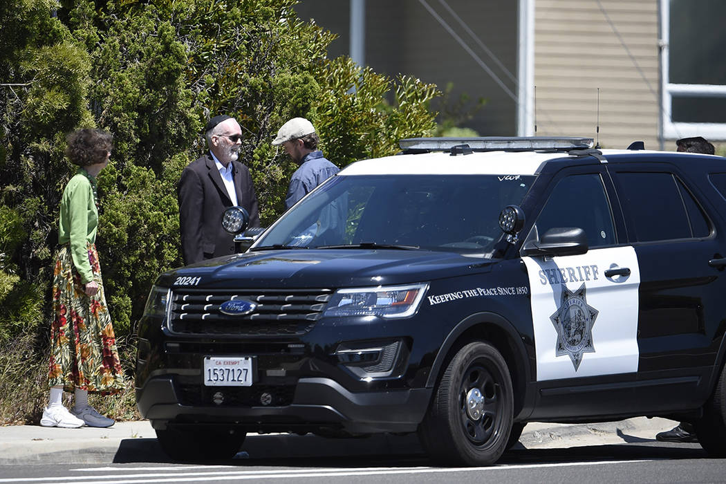 Synagogue members stand outside of the Chabad of Poway Synagogue Saturday, April 27, 2019, in P ...