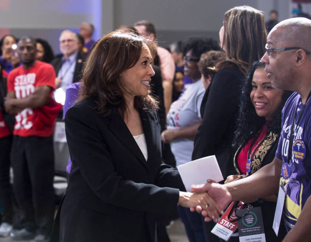 Presidential candidate Sen. Kamala Harris, left, D-Calif., shakes hands with supporters during ...