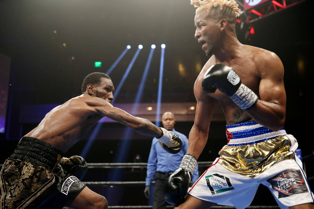 Robert Easter Jr., left, throws a punch against Rances Barthelemy in the WBA lightweight champi ...