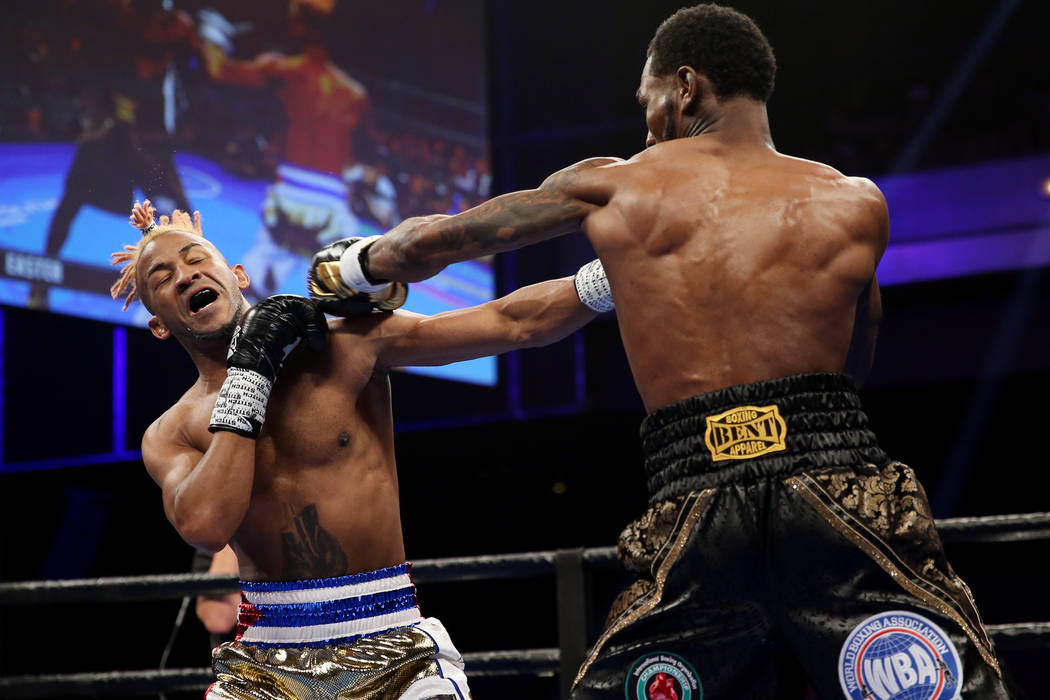 Rances Barthelemy, left, takes a punch from Robert Easter Jr. in the WBA lightweight championsh ...