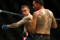 Dustin Poirier, left, fights Max Holloway during an interim lightweight title mixed martial art ...