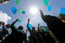 FILE - In this July 20, 2106 file photo, East Baton Rouge Sheriff's deputies release balloons a ...