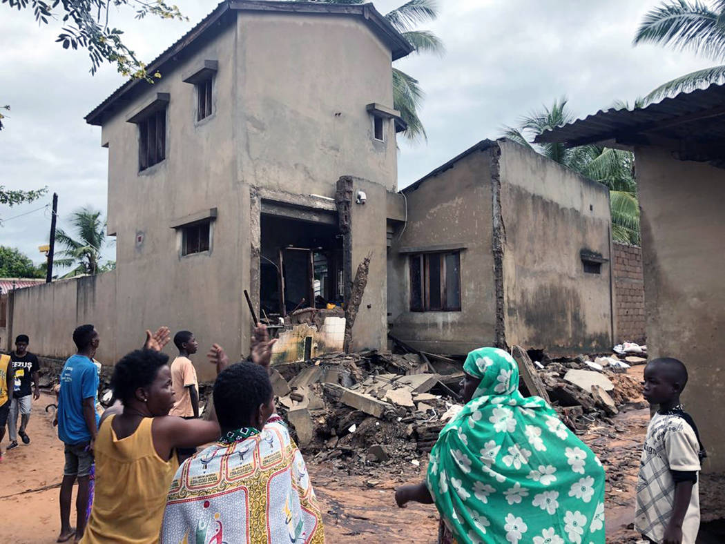 Residents of Nitate, Pemba, looking at a house that got damaged by floodwaters in northern Moza ...