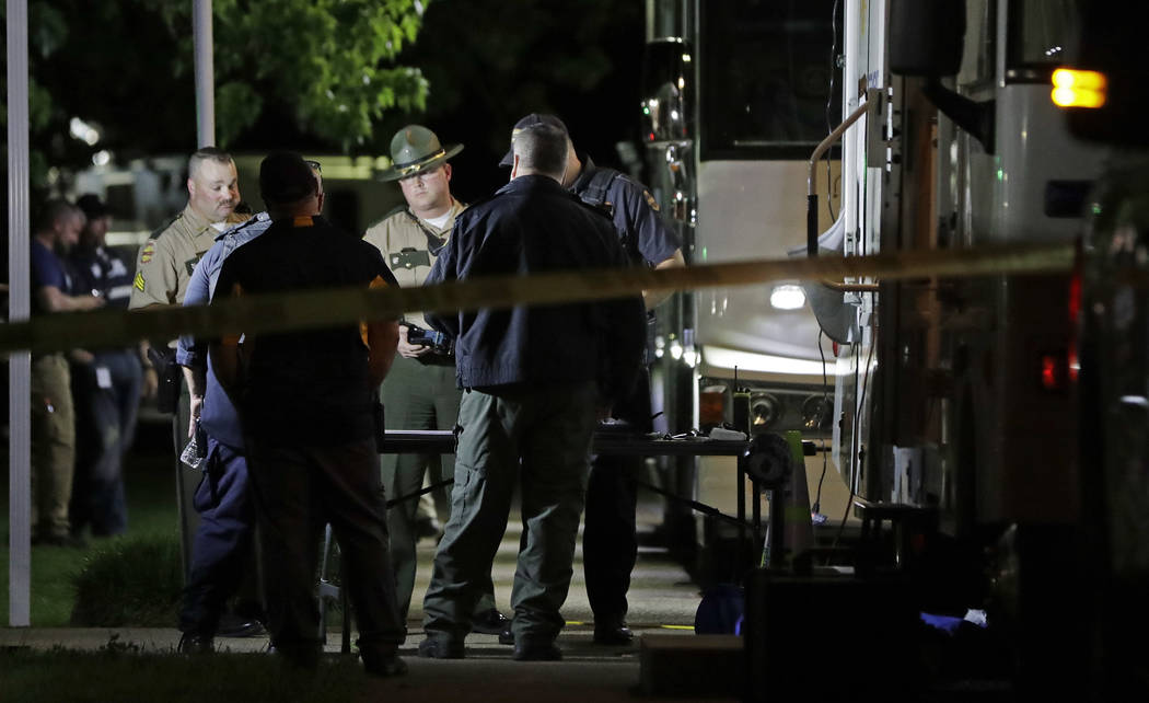 Law enforcement officials work at a command center set up at North Sumner Elementary School Sat ...