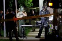 Law enforcement officials work at a command center set up at North Sumner Elementary School Sat ...