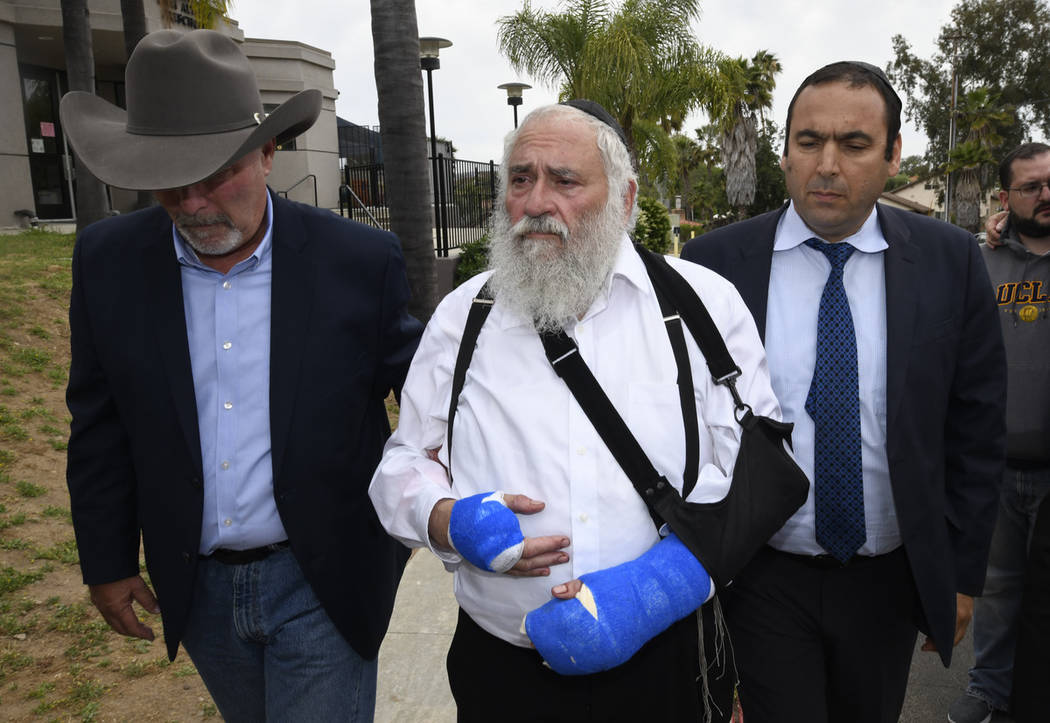 Rabbi Yisroel Goldstein, center, arrives for a news conference at the Chabad of Poway synagogue ...