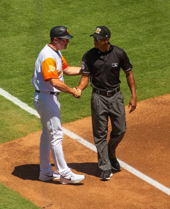 Aviators manager Fran Riordan (39) greets one of the umpires as his team faces El Paso at the L ...