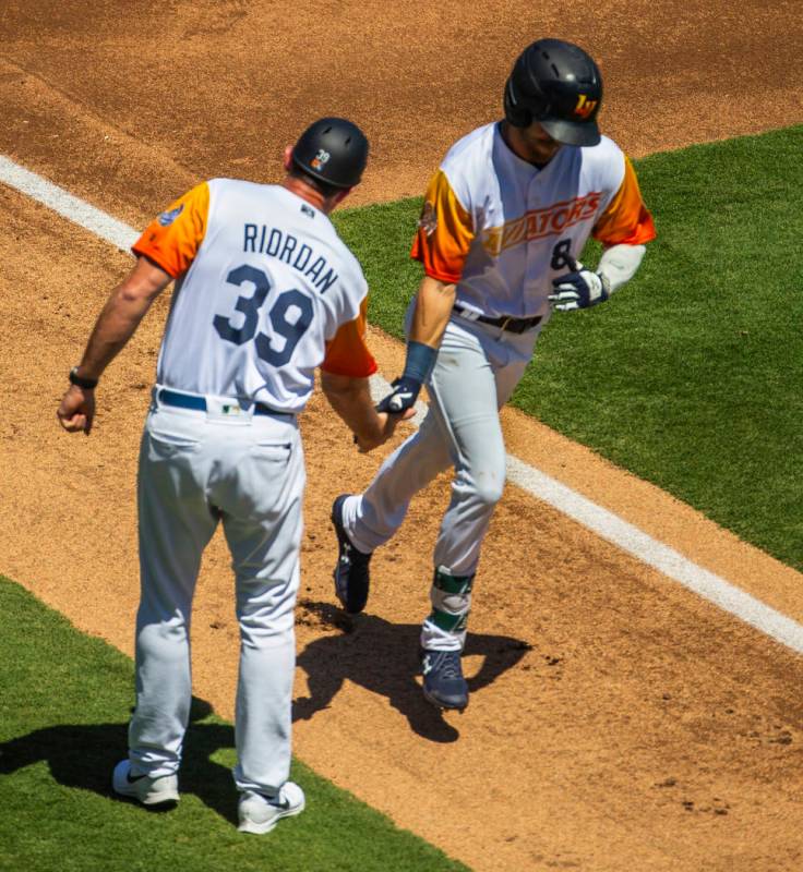 Aviators manager Fran Riordan (39) congratulates base runner Skye Bolt (8) on a score as he rou ...