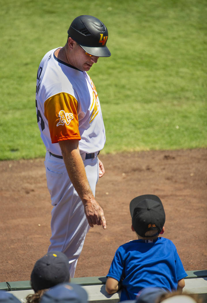 Aviators manager Fran Riordan (39) instructs a young fan to careful and stay off the field afte ...