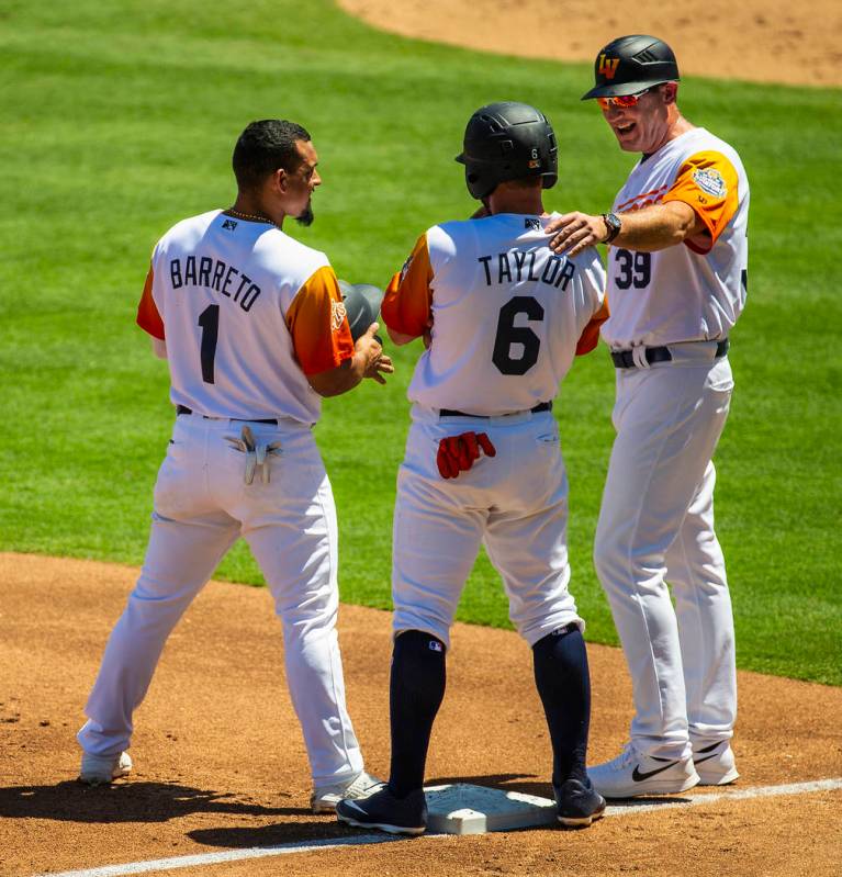 (From right) Aviators manager Fran Riordan (39) shares a laugh with base runners Beau Taylor (6 ...