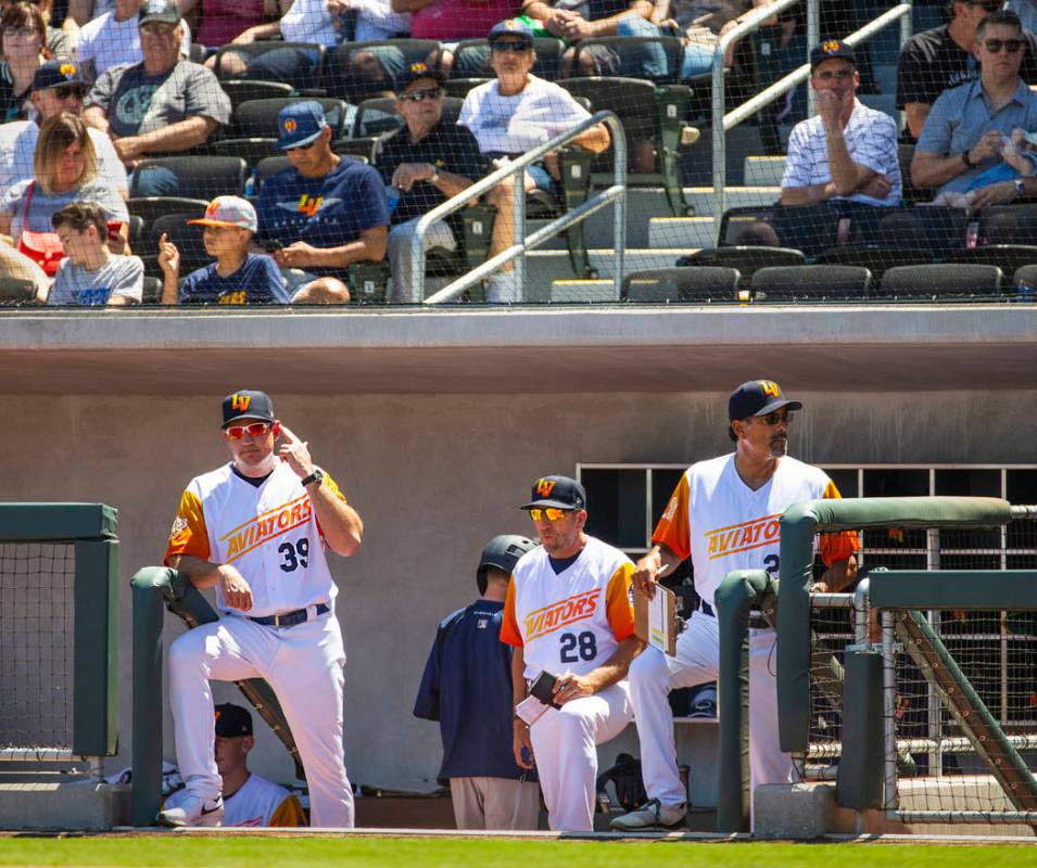 Aviators manager Fran Riordan (39) sends in signals to his batter with coaches Craig Conklin (2 ...