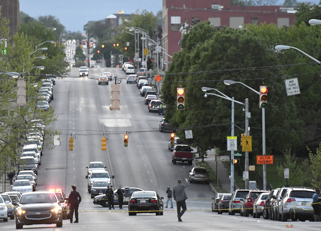 Police work near the scene where authorities say several people were shot, at least one fatally ...