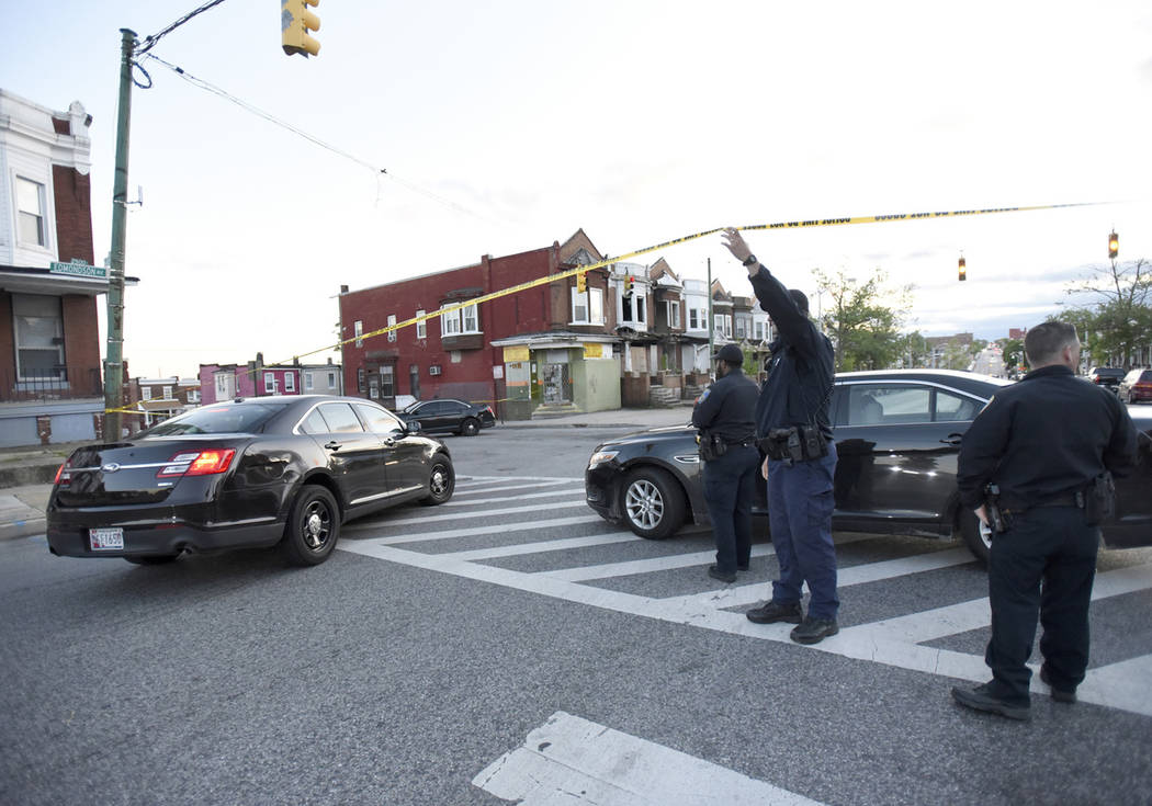 Police work near the scene where authorities say several people were shot, at least one fatally ...