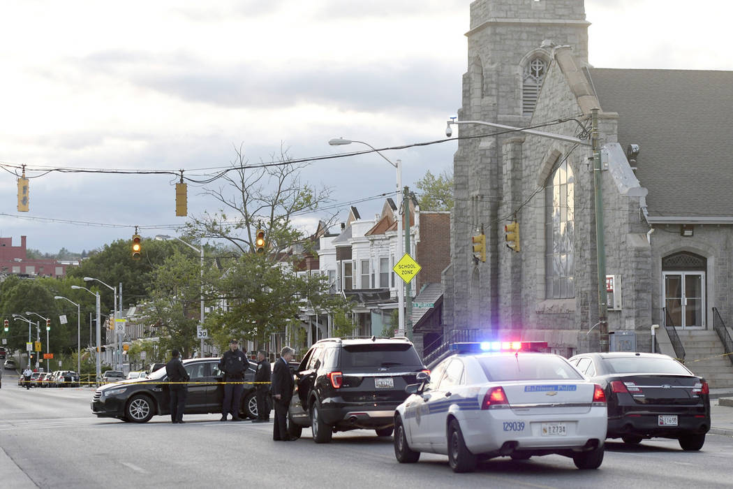 Police work near the scene where authorities say several people were shot, at least one fatally ...