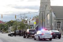 Police work near the scene where authorities say several people were shot, at least one fatally ...