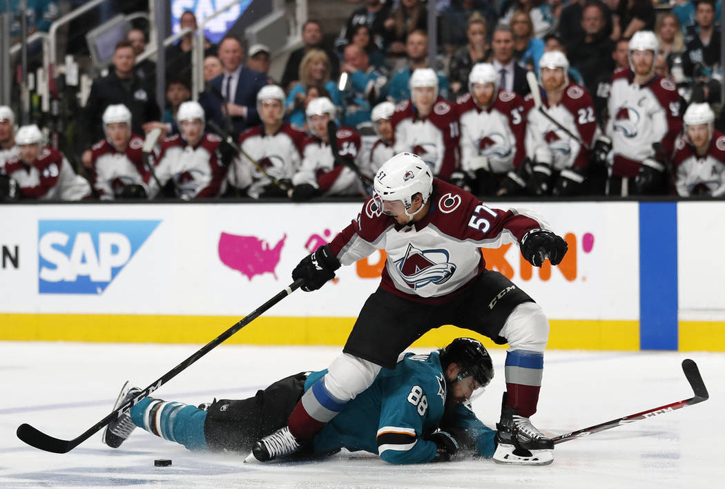 Colorado Avalanche's Gabriel Bourque (57) battles for the puck against San Jose Sharks' Brent B ...