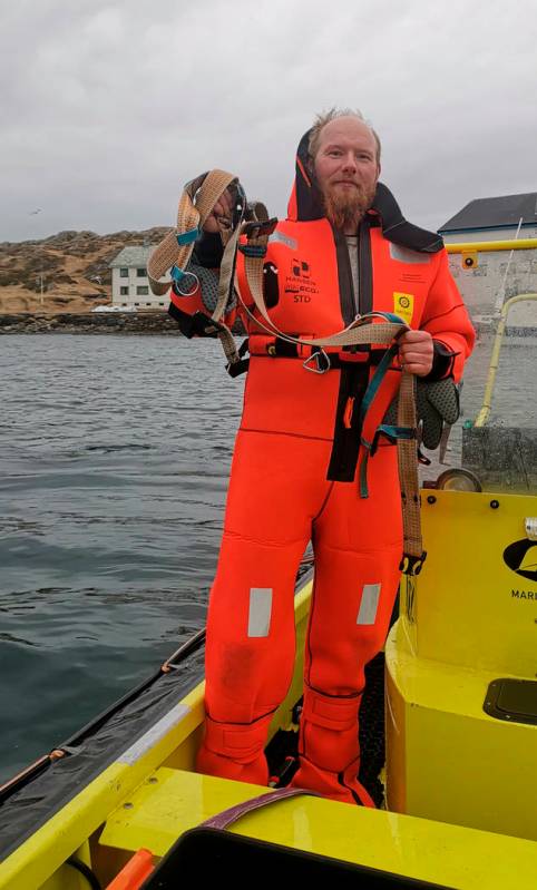 Norwegian Joergen Ree Wiig holds the whale harness after it was removed from a beluga whale off ...