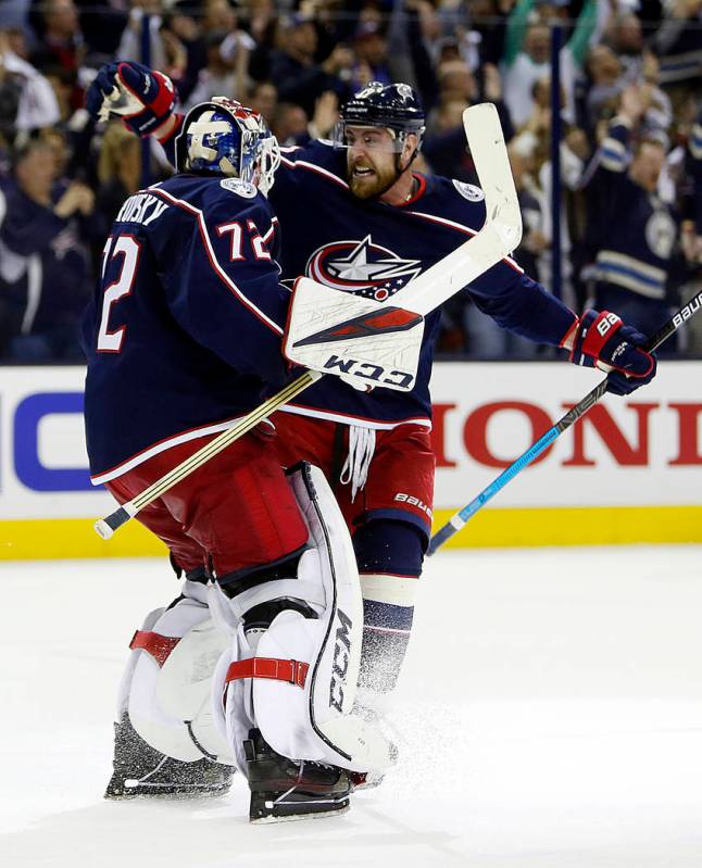 Columbus Blue Jackets' Sergei Bobrovsky, left, of Russia, and Brandon Dubinsky celebrate their ...