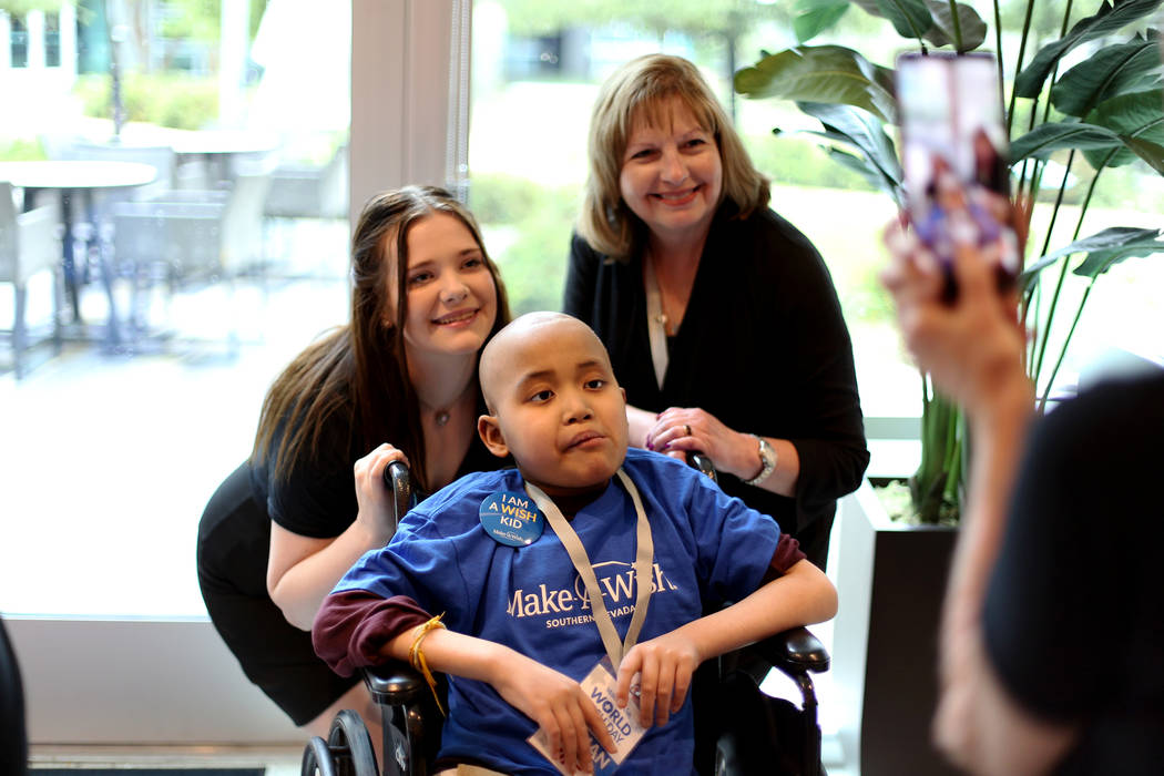 Make-A-Wish staff Amber McKierna, from left, poses with fellow employee Annette Fuentes and wis ...