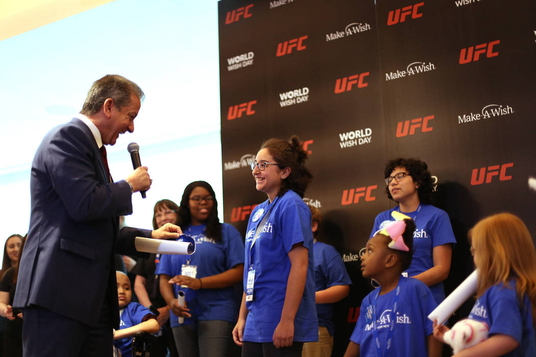 Bruce Buffer, the official announcer for UFC events, tells Aileen Say Sanchez, 15, that her wis ...