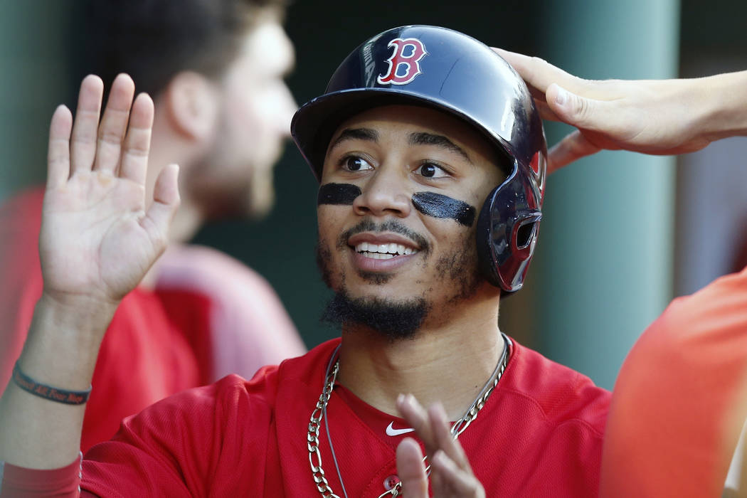 In this Friday, July 13, 2018 file photo,Boston Red Sox's Mookie Betts celebrates after scoring ...