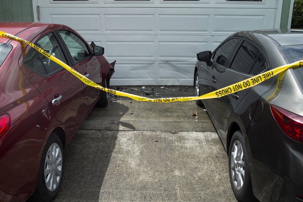 Debris lays on the ground where parts of a helicopter hit a parked car, Monday, April 29, 2019, ...