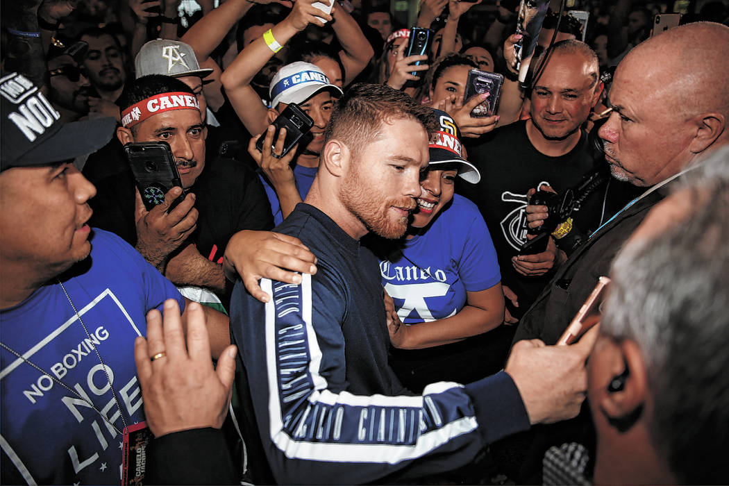 Saul "Canelo" Alvarez takes a photo with a fan during his grand arrival at MGM Grand ...