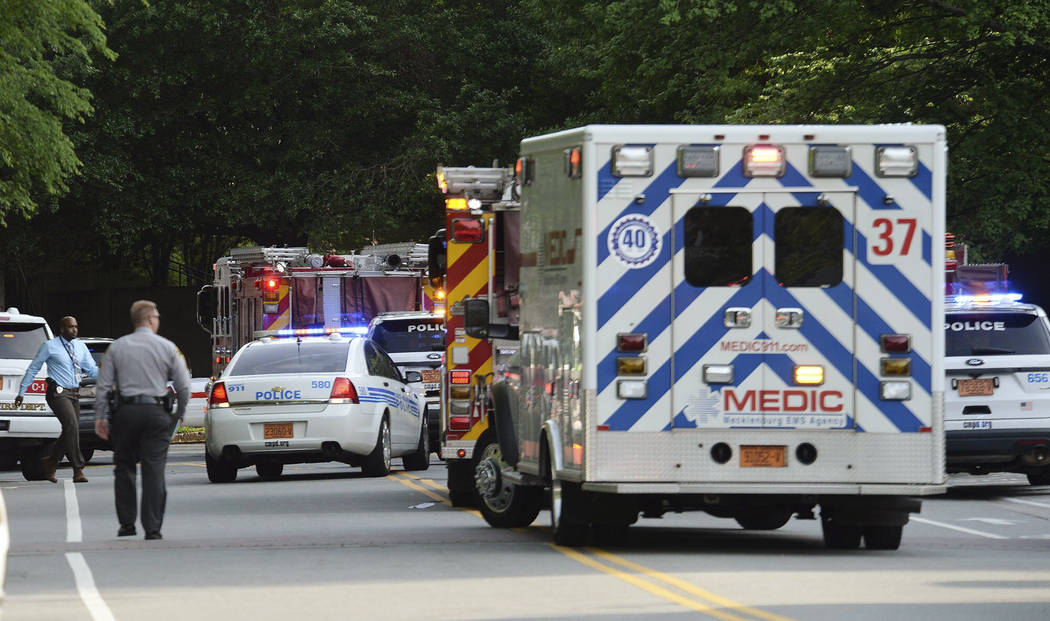 Emergency vehicles cluster on Mary Alexander Road on the campus of University of North Carolina ...