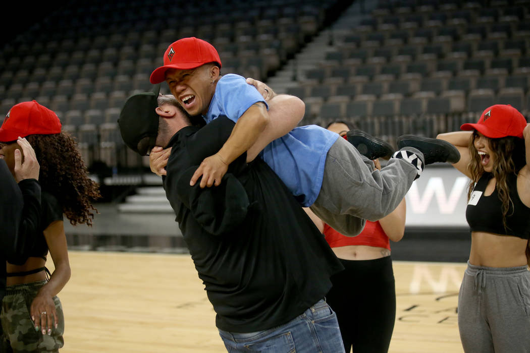 WNBA Las Vegas Aces Wild Card Crew member Jordan Cline, 34, of Las Vegas, facing, gets a hug fr ...