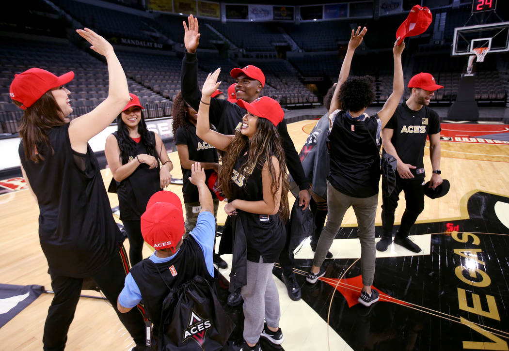 Members of the WNBA Las Vegas Aces Wild Card Crew, celebrate after finding out they made the te ...