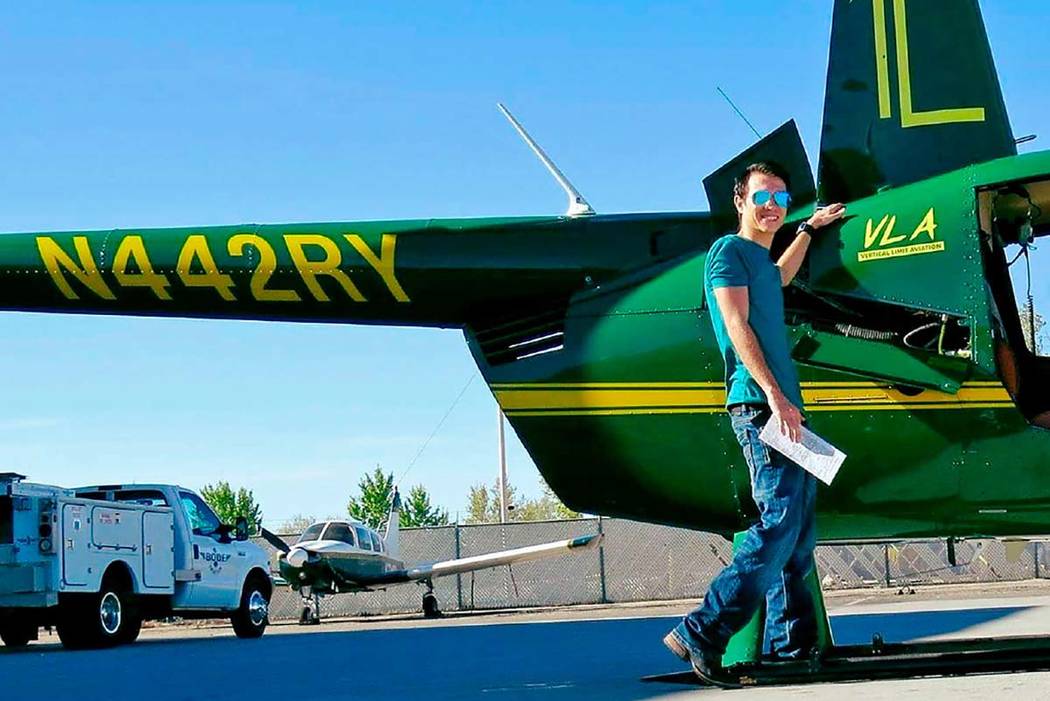 This 2018 photo provided by Bobby Berridge shows his son, Joseph Berridge, with a Robinson R44 ...