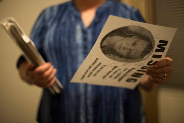 Rhonda Hunnel holds a missing person flyer for her daughter Regina Krieger at her home in Hende ...