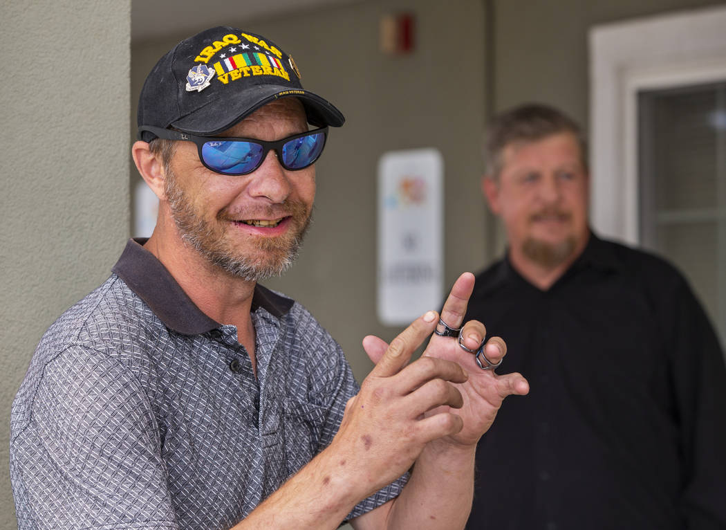 Friends Christian Bridges and Ron Cochran chat outside their apartments in Las Vegas on Monday, ...