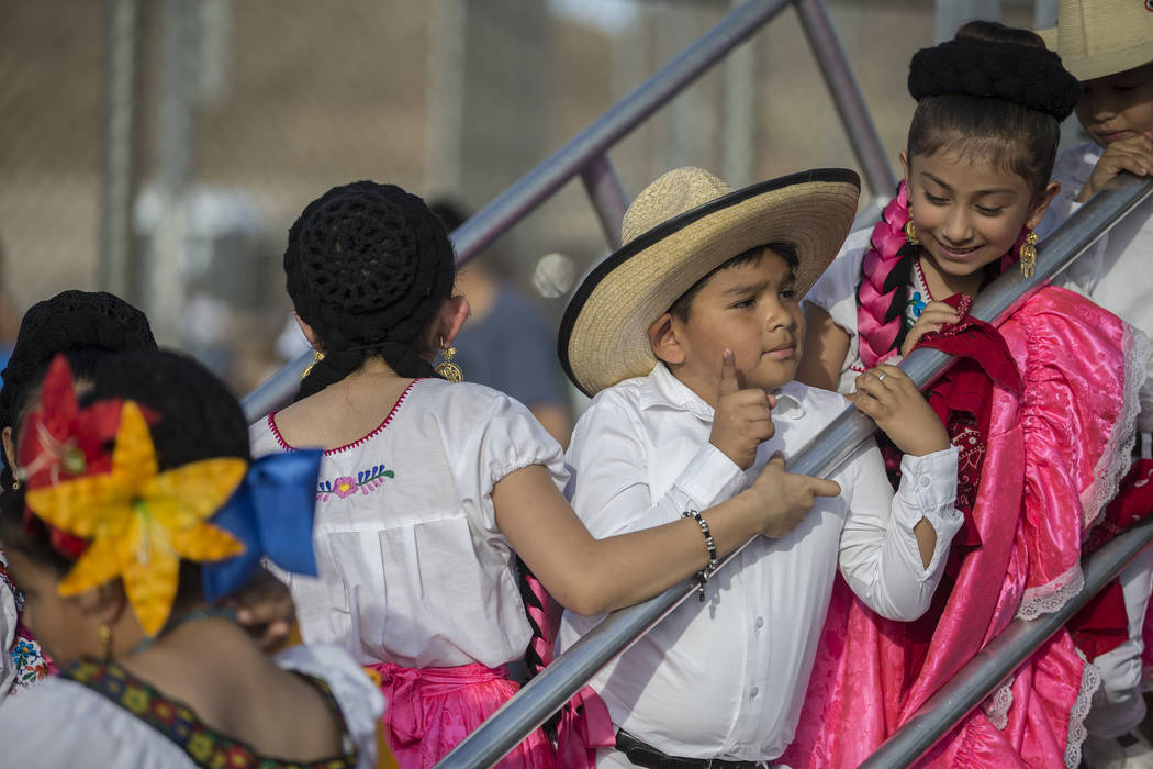 Dancers with Federación de Poblanos en Las Vegas get ready to go on stage during a Cinco de Ma ...