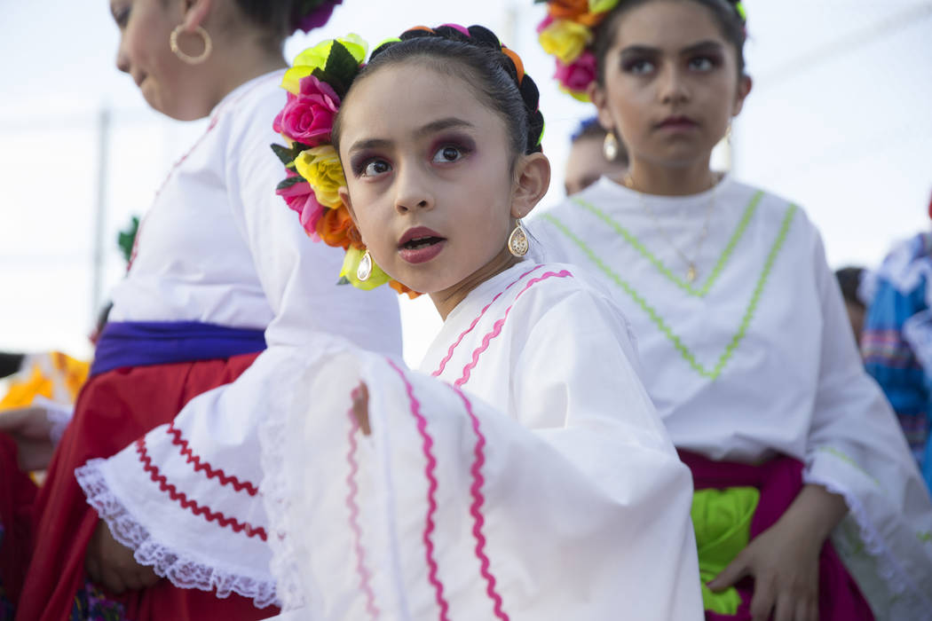 Rocio Ramirez with Federación de Poblanos en Las Vegas get ready to go on stage during a Cinco ...