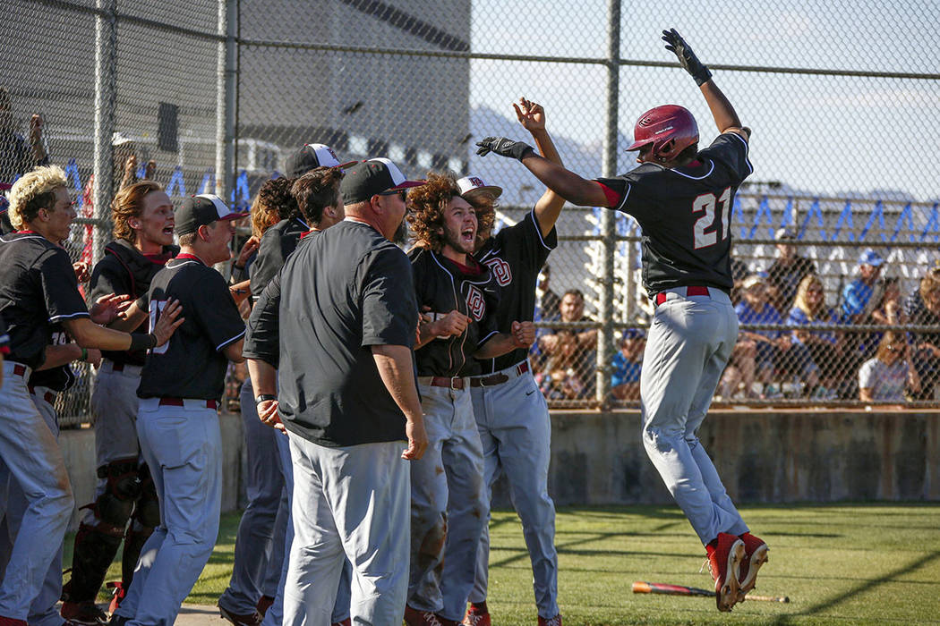 Desert Oasis pitcher Jacob Walsh (21) is congratulated by his teammates after hitting a home ru ...