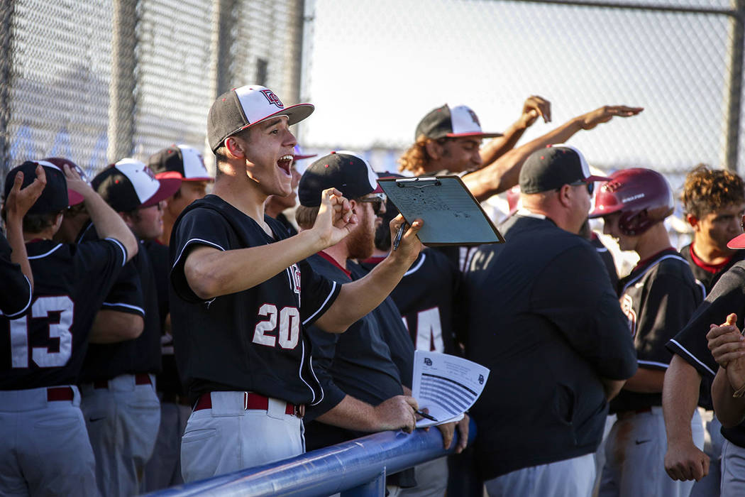 Desert Oasis pitcher Jacob Baca (20) cheers along with his teammates after three runs are score ...